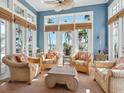 Bright sunroom featuring water views, casual seating, and natural light perfect for relaxation and entertaining at 2110 Casey Key Rd, Nokomis, FL 34275