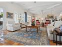 Inviting living room with comfortable seating, a large rug, and elegant decor perfect for relaxation and gatherings at 2110 Casey Key Rd, Nokomis, FL 34275