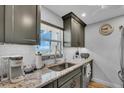 Well lit kitchen with granite countertops, stainless steel appliances, and a view from the window at 232 Saint Augustine Ave # 802, Venice, FL 34285