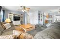 Spacious living room featuring hardwood floors, ceiling fan, and built-in shelving at 308 Purdue Rd, Venice, FL 34293