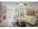 Cozy living room featuring tile floors, ceiling fan, and comfortable seating arrangements at 3224 Mount Hope St, North Port, FL 34287