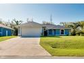Attractive single-story home with an attached two-car garage and concrete driveway at 3447 Nadasky Ave, North Port, FL 34288