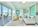 Relaxing sunroom featuring water views, comfortable seating, and convenient access to the kitchen at 483 Circlewood Dr # O14, Venice, FL 34293