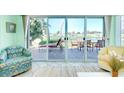 Cozy living room showcasing large glass doors with serene lake views and comfortable seating arrangement at 483 Circlewood Dr # O14, Venice, FL 34293