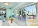 Bright living room with sliding glass doors offering scenic water views and an airy atmosphere at 483 Circlewood Dr # O14, Venice, FL 34293