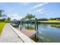 Scenic waterfront property featuring a private dock with boat lift at 51 Oakwood N Dr # 51, Englewood, FL 34223