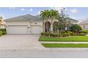 Beautiful home with a three-car garage, brick paved driveway, and covered front entry with decorative columns at 5550 Rock Dove Dr, Sarasota, FL 34241
