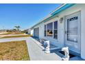 Well-kept home with decorative dolphin statues flanking the entrance and a neatly maintained lawn at 6392 Coliseum Blvd, Port Charlotte, FL 33981