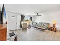 Bright living room with tile flooring, a ceiling fan, and comfortable seating arrangement at 6392 Coliseum Blvd, Port Charlotte, FL 33981