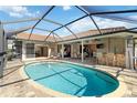 Relaxing screened-in pool area with brick pavers, outdoor seating, bar area, and an inviting pool at 7324 Links Ct, Sarasota, FL 34243