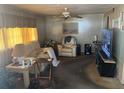 Cozy living room with comfortable seating, a ceiling fan, and a large television at 733 Roma Rd, Venice, FL 34285