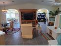 Open-concept living room with neutral tones, archways, and comfortable seating for relaxing at 805 S Waterway, Venice, FL 34285