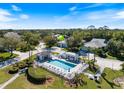 Stunning aerial view of a community pool and surrounding neighborhood at 915 Tartan Dr # 29, Venice, FL 34293