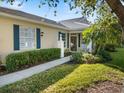 Beautiful home featuring manicured hedges, and dark shutters that compliment the exterior at 915 Tartan Dr # 29, Venice, FL 34293
