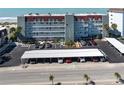 Aerial view of condo building, parking, beach, and ocean showcasing the location and amenities at 950 Tarpon Center Dr # 506, Venice, FL 34285