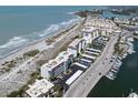 Stunning aerial view of the condo building near the beach, parking, and marina at 950 Tarpon Center Dr # 506, Venice, FL 34285