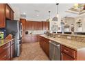 Spacious kitchen featuring stainless steel appliances, granite countertops and beautiful wood cabinetry at 10139 Kansas City St, Port Charlotte, FL 33981