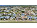 Aerial view of neighborhood homes in a circle, featuring pools, landscaping and neatly arranged layouts at 1048 Ulrey Ln, Englewood, FL 34223