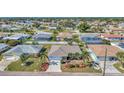 Residential neighborhood with single-Gathering homes, showcasing a well-maintained property with lush landscaping at 1048 Ulrey Ln, Englewood, FL 34223