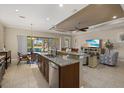 Open concept kitchen featuring granite countertops, stainless steel appliances, and a breakfast bar at 124 Pesaro Dr, North Venice, FL 34275