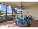 Relaxing screened-in lanai featuring comfortable seating and a view of the lush backyard at 124 Pesaro Dr, North Venice, FL 34275