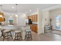 Open-concept living space featuring a kitchen, breakfast bar and entryway at 12565 Canavese Ln, Venice, FL 34293