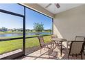 Relaxing screened porch with brick flooring, a ceiling fan, and views of the pond and outdoor scenery at 12565 Canavese Ln, Venice, FL 34293