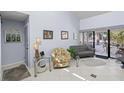 Bright and airy living room with neutral tones, tile flooring, stylish furnishings, and sliding door to outdoor living at 1555 Tarpon Center Dr # 255, Venice, FL 34285