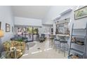 Spacious living room with bar seating, high ceilings, tile floors, stylish decor, and bright, airy atmosphere at 1555 Tarpon Center Dr # 255, Venice, FL 34285