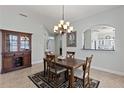 Dining room featuring a chandelier and furniture set on a patterned rug at 1572 Monarch Dr, Venice, FL 34293