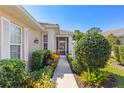 Inviting walkway leads to the front entrance surrounded by lush, tropical landscaping at 1572 Monarch Dr, Venice, FL 34293