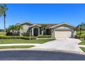 Well-maintained home with a spacious driveway, two-car garage, and neatly trimmed landscaping at 1763 Cartina Way, Venice, FL 34292