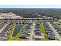 An aerial view showcases the home nestled in a well-planned community and views of surrounding natural areas at 1766 Sunset Preserve Way, Port Charlotte, FL 33953