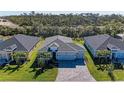 Aerial view of the house displaying the roof, landscaping, and gray brick driveway at 1766 Sunset Preserve Way, Port Charlotte, FL 33953