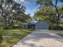 Charming single Gathering home featuring a two car garage and a brick driveway at 1769 Manasota Beach Rd, Englewood, FL 34223