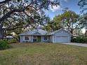 Charming single Gathering home with manicured lawn and cozy front porch at 1769 Manasota Beach Rd, Englewood, FL 34223
