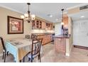 Charming kitchen and dining area with wooden cabinets, granite countertops, and natural lighting at 200 The Esplanade N # B3, Venice, FL 34285