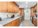 Well-equipped kitchen with warm wood cabinets, stainless steel appliances, and granite countertops at 2102 Alaric St, Port Charlotte, FL 33952