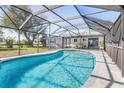 Inviting screened-in pool with ample seating, perfect for relaxation and outdoor entertaining at 2102 Alaric St, Port Charlotte, FL 33952