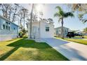 Charming single-story home with lush green lawn, complemented by mature trees and a bright facade at 223 Lancer Dr, Nokomis, FL 34275