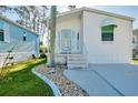Inviting front entrance with stone-accented steps and a decorative glass door at 223 Lancer Dr, Nokomis, FL 34275