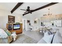 Cozy living room with a tv, accent chair, and a view into the open kitchen and dining area at 238 Tampa W Ave # 217, Venice, FL 34285