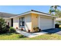 Well-maintained home with a clean exterior, showcasing fresh landscaping and an attached garage at 334 Pembroke S Ln # 219, Venice, FL 34293