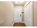Cozy entryway featuring wood floors, a coat closet, and a white front door at 3417 Clark Rd # 217, Sarasota, FL 34231