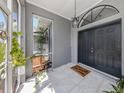 The entryway is tiled with black double doors and a 'Home Sweet Home' welcome mat at 4070 Kincord Ln, North Port, FL 34287