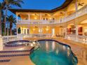 Backyard oasis featuring a sparkling pool, spa, and covered veranda with kitchen, perfect for outdoor entertaining and relaxation at 416 Baycrest Dr, Venice, FL 34285