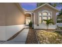 Charming front entrance with double doors, decorative windows, and landscaped walkway leading to the home at 419 Shore Rd, Nokomis, FL 34275