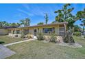 Inviting exterior showcasing the home's facade, green lawn, and pleasant landscaping at 4437 Tippecanoe Trl # 6, Sarasota, FL 34233