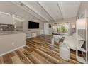 Bright living room featuring wood flooring, modern furnishings, vaulted ceilings, and sliding glass doors to patio at 500 N Jefferson Ave # A3, Sarasota, FL 34237