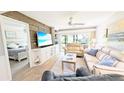 Inviting living room with a beach house theme, comfortable seating, and view of the screened lanai at 512 W Venice Ave # 102, Venice, FL 34285